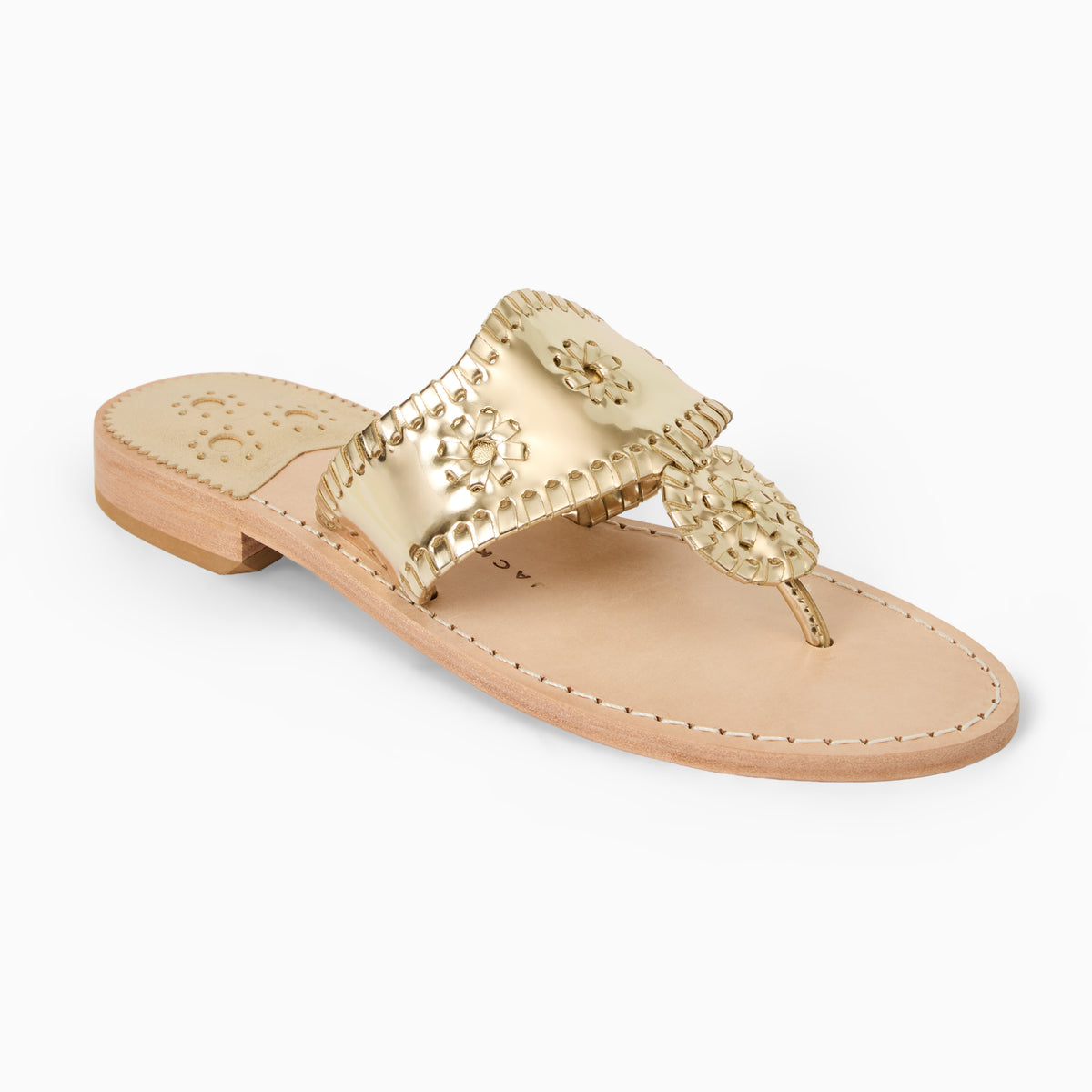 A flat thong sandal with a metallic gold whipstitched strap and matching rondel medallion, set against a clean white background.