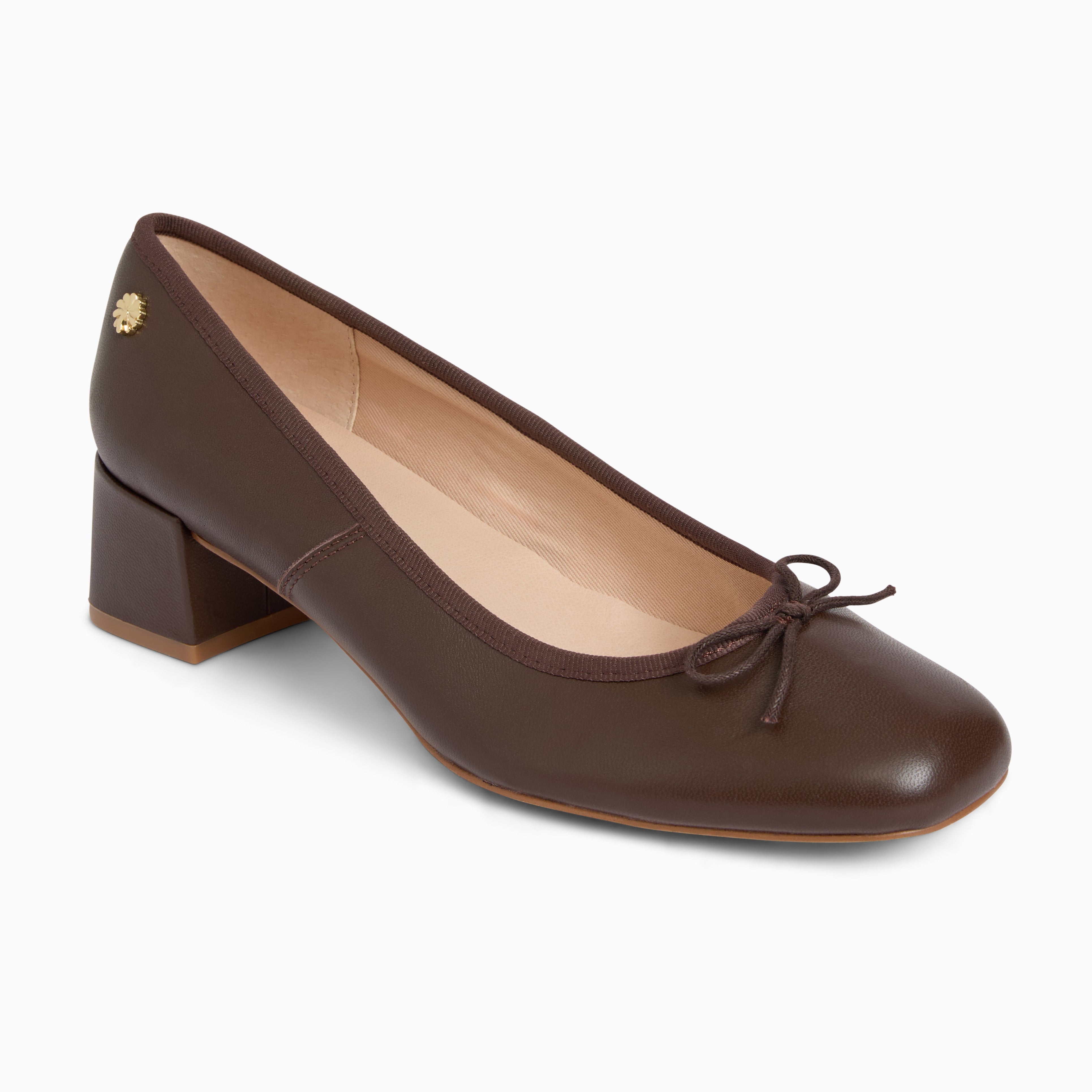 A dark brown leather pump shoe with a low block heel, a small matching fabric bow on the toe, and a small gold-tone decorative stud on the heel, shown against a plain white background.